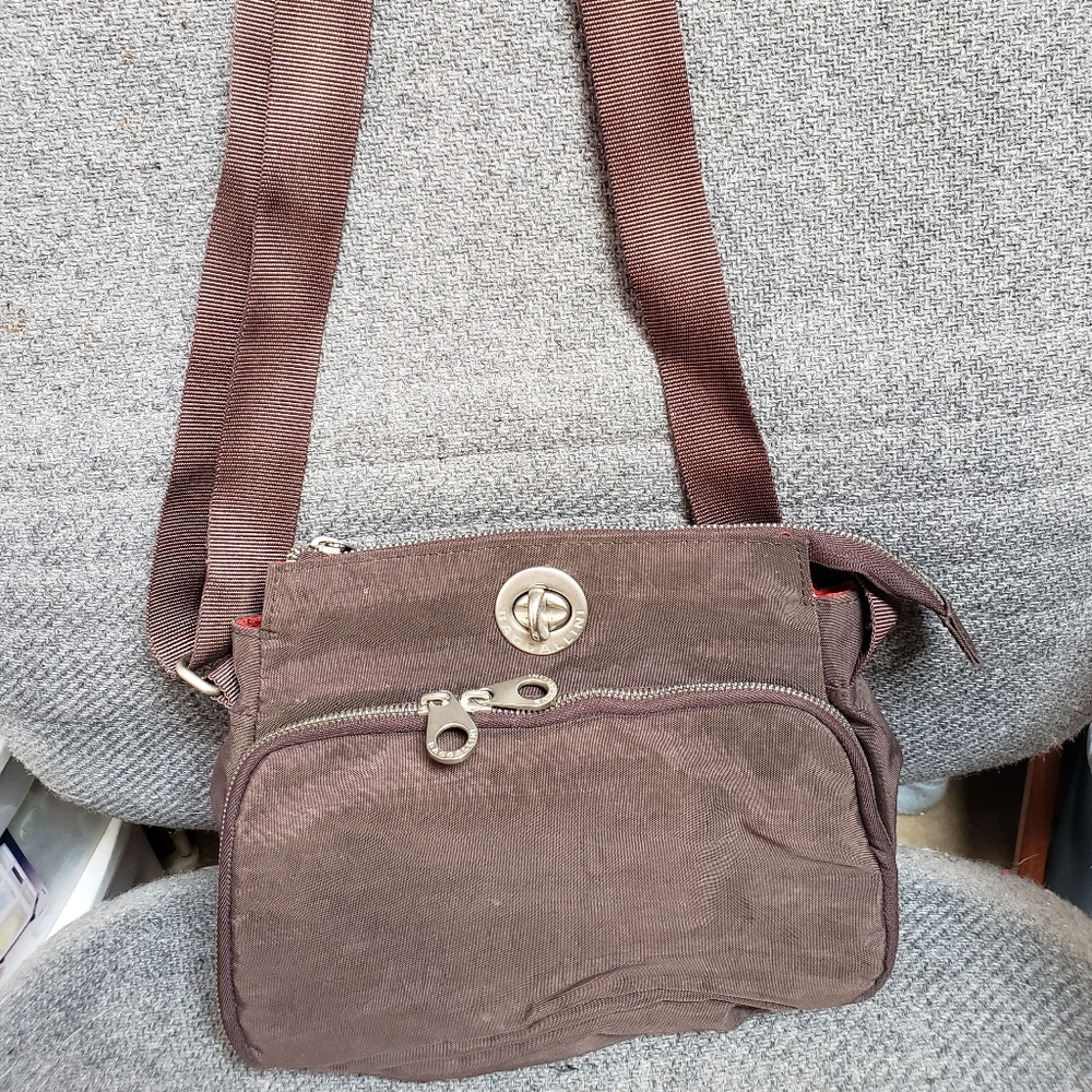 Baggallini Bag with multiple pockets..Dark Brown/Black with Red interior.